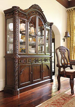 Inspired by the grandeur and grace of Old World traditional style, the North Shore buffet and hutch is nothing short of stunning.  A choice blend of materials is accented by the most intricate carvings and appliques. Designed for modern convenience, buffet includes three felt-lined drawers and shelved cabinet space to serve your storage needs exceptionally well. Illuminated hutch with mirrored back and glass shelves makes for gorgeous displays.Made of veneers, wood, engineered wood and cast resin | Hand-finished | Antiqued goldtone hardware | Buffet with 3 lined drawers (1 with silverware liner) and 2 cabinets with 2 shelves (1 adjustable) | Hutch with 3 cabinets with glass doors and 3 shelves; LED lighting (3-way switch located on outer door hinge controls the light) | Assembly required | Excluded from promotional discounts and coupons | Estimated Assembly Time: 5 Minutes