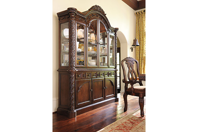Inspired by the grandeur and grace of Old World traditional style, the North Shore dining room server is nothing short of stunning. A choice blend of materials is accented by the most intricate appliques. And it’s so functional. Four center drawers, two top side drawers and shelved cabinet space behind each door serve your storage needs exceptionally well.Made of veneers, wood, engineered wood and cast resin | Hand-finished | Antiqued goldtone hardware | 3 lined drawers; 1 with silverware liner | 2 cabinets, each with 1 adjustable shelf | Assembly required