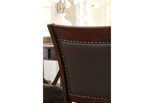 Pull up a seat and casually dine in the comfort of the Collenburg counter height bar stool. Luscious upholstery covering the seat's cushion and back, along with the leg rest, make this stool inviting. Rich dark brown finish and nailhead trim complete the upscale look.Made of wood | Counter height | Vinyl upholstery over foam cushion and inset back | Nailhead trim on chair's back | Assembly required | Excluded from promotional discounts and coupons | Estimated Assembly Time: 30 Minutes