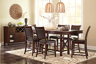 Pull up a seat and casually dine in the comfort of the Collenburg counter height bar stool. Luscious upholstery covering the seat's cushion and back, along with the leg rest, make this stool inviting. Rich dark brown finish and nailhead trim complete the upscale look.Made of wood | Counter height | Vinyl upholstery over foam cushion and inset back | Nailhead trim on chair's back | Assembly required | Excluded from promotional discounts and coupons | Estimated Assembly Time: 30 Minutes