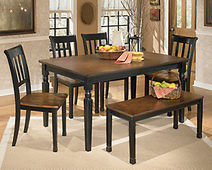 The farmhouse table is more in style than ever—and the Owingsville 6-piece dining room set brings it back in brilliant fashion. The rectangular table, 4 chairs and bench don a subtle two-tone finish for a look that's equally homey and sophisticated. Vintage inspiration at its best.Includes dining table, 4 chairs and bench | Table, chairs and bench made of veneers, wood and engineered wood | Table tops, chair seats and bench seat are finished in a burnished brown color | Table bases, chair and bench frames are finished in cottage black paint | Assembly required