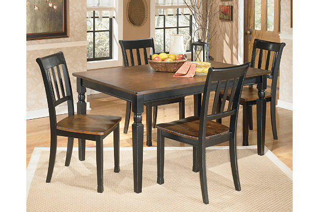 The farmhouse table is more in style than ever—and the Owingsville 5-piece dining room set brings it back in brilliant fashion. The rectangular table and 4 chairs don a subtle two-tone finish for a look that's equally homey and sophisticated. Vintage inspiration at its best.Includes dining table, 4 chairs  | Table and chairs made of veneers, wood and engineered wood | Table top and chair seats are finished in a burnished brown color | Table bases and chair frames are finished in cottage black paint | Assembly required