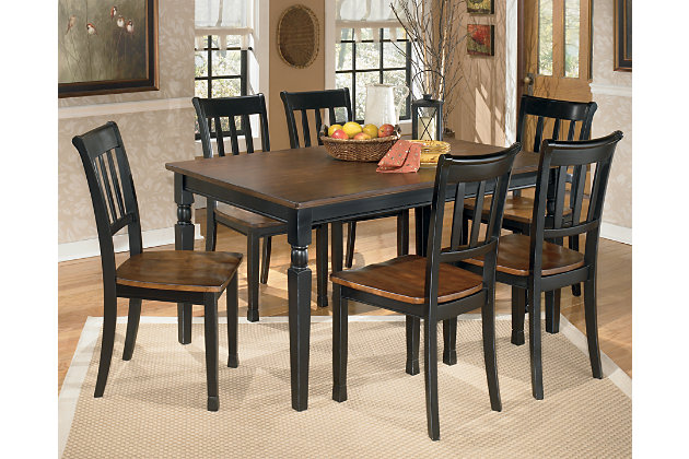 The farmhouse table is more in style than ever—and the Owingsville 7-piece dining room set brings it back in brilliant fashion. The rectangular table and 6 chairs don a subtle two-tone finish for a look that's equally homey and sophisticated. Vintage inspiration at its best.Includes dining table, 6 chairs  | Table and chairs made of veneers, wood and engineered wood | Table top and chair seats are finished in a burnished brown color | Table bases and chair frames are finished in cottage black paint | Assembly required