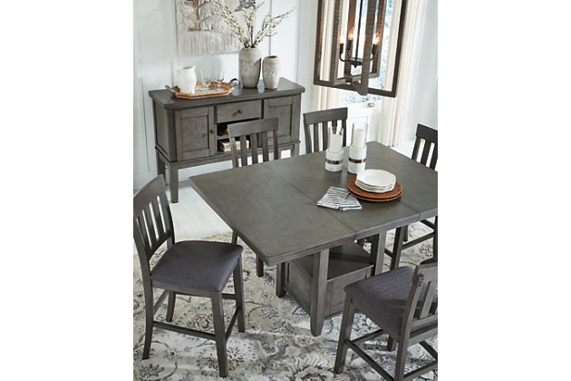 Cool and on-trend. The Hallanden counter height extension table sports an antiqued gray color for a contemporary-yet-casual feel. The table features a storage base and removable leaf for extra seating room, making it a breeze to clear off clutter and expand your table space. Dining with friends and family has never been so stylish. Made with hardwood solids, select acacia veneer and engineered wood | Antiqued gray finish | Storage base | Removable leaf | Assembly required | Estimated Assembly Time: 30 Minutes