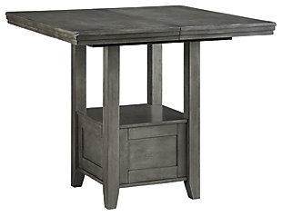 Cool and on-trend. The Hallanden counter height extension table sports an antiqued gray color for a contemporary-yet-casual feel. The table features a storage base and removable leaf for extra seating room, making it a breeze to clear off clutter and expand your table space. Dining with friends and family has never been so stylish. Made with hardwood solids, select acacia veneer and engineered wood | Antiqued gray finish | Storage base | Removable leaf | Assembly required | Estimated Assembly Time: 30 Minutes