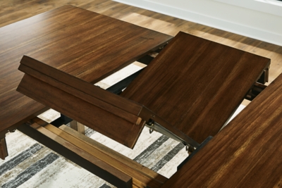 Extendable dining table with leaf panels opened