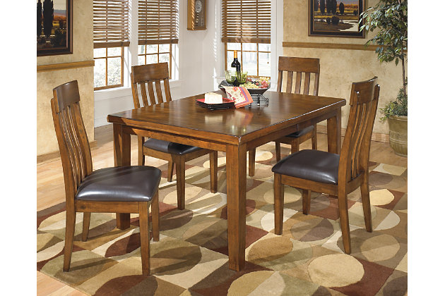 Have an appetite for clean-lined design, but with warmth and rustic character? Satisfaction is served with the Ralene butterfly extension dining room table set. We love how the gently distressed, burnished finish and plank-style tabletop incorporates depth and character. And the plushly upholstered chairs? A wonderful display of good taste.Includes dining table and 4 upholstered chairs | Made of veneers, wood and engineered wood | Faux leather upholstery | 1 self-storing butterfly extension leaf | Seats up to 8 | Assembly required | Estimated Assembly Time: 90 Minutes