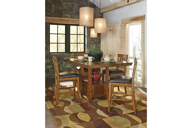 Have an appetite for clean-lined design, but with warmth and rustic character? Satisfaction is served with the Ralene dining room set. Its gently distressed, burnished finish and shelf-style pedestal incorporate depth and character. While the separate extension leaf easily expands your seating options. Bar stools with cushioned faux leather upholstery are a wonderful show of good taste.Includes dining table and 4 upholstered bar stools | Table made of veneers, wood and engineered wood | Bar stools made of wood | Hand-finished | Fixed shelf | Separate extension leaf | Table extends by pulling both ends and dropping in leaf | Assembly required | Seats up to 6 | Estimated Assembly Time: 210 Minutes