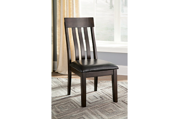 Take clean-lined, classic styling. Add modern comfort. Top with a deep, complex finish that exudes rich sophistication. That’s the look and feel of the Haddigan dining room chair. Wide-slat, rake-back design with lumbar curve and cushioned upholstered seat make it complete.Wood frame | Cushioned vinyl upholstered seat | Assembly required | Excluded from promotional discounts and coupons | Estimated Assembly Time: 30 Minutes