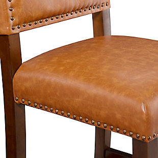Raise the bar on style with this upscale upholstered bar stool. Brown wood frame is a pleasing complement to the caramel brown faux leather upholstery that's a smart choice for low-maintenance living. Thickly padded seat caters to your comfort level.Made of wood | Brown finish | Brown/caramel vinyl/polyester upholstery | Foam cushioned seat | Protective glides under legs | Assembly required