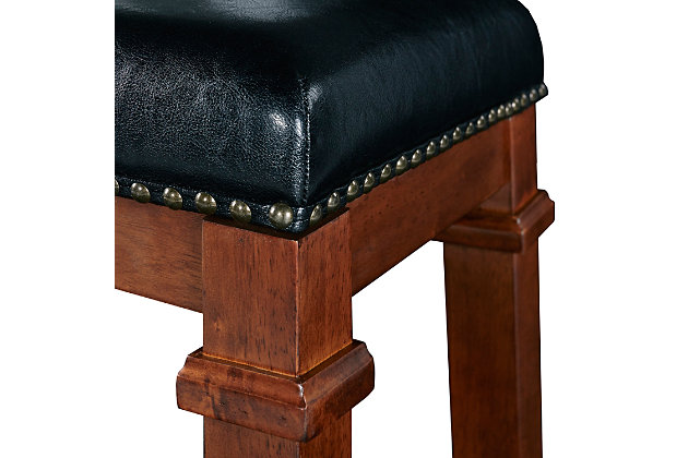 Raise the bar on style with this simply striking upholstered bar stool in dark cherry finish with black upholstery. Thickly padded seat covered in easy-clean vinyl caters to your comfort level.Made of wood | Dark cherry finish | Faux leather upholstery with foam padding | Contoured saddle seat | Nailhead trim | Footrest | Protective glides under legs | Assembly required