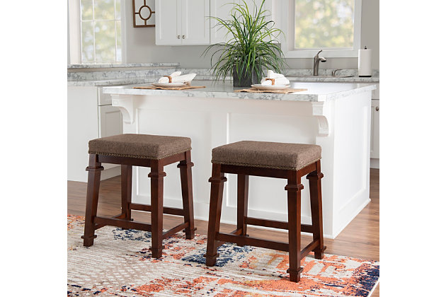 Raise the bar on style with this simply striking upholstered bar stool in walnut finish with brown tweed upholstery. Thickly padded seat covered in easy-clean fabric caters to your comfort level.Made of wood | Walnut finish | Tweed upholstery with foam padding | Nailhead trim | Footrest | Protective glides under legs | Assembly required