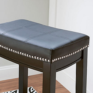 Raise the bar on style with this simply striking upholstered bar stool in black with black upholstery. Thickly padded seat covered in easy-clean vinyl caters to your comfort level.Made of wood | Black finish | Faux leather upholstery with foam padding | Contoured saddle seat | Nailhead trim | Footrest | Protective glides under legs | Assembly required