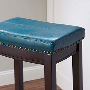 Raise the bar on style with this simply striking upholstered bar stool in dark brown with blue upholstery. Thickly padded seat covered in easy-clean vinyl caters to your comfort level.Made of wood | Dark brown finish | Faux leather upholstery with foam padding | Contoured saddle seat | Nailhead trim | Footrest | Protective glides under legs | Assembly required
