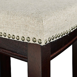 Raise the bar on style with this upscale upholstered bar stool. Dark walnut finished wood frame is a striking contrast to the richly woven linen upholstery punctuated with nailhead trim. Thickly padded seat caters to your comfort level.Made of wood | Walnut finish | Beige linen upholstery with foam padding | Contoured saddle seat | Nailhead trim | Footrest | Protective glides under legs | Assembly required