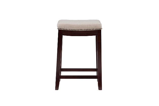Raise the bar on style with this upscale upholstered bar stool. Dark walnut finished wood frame is a striking contrast to the richly woven linen upholstery punctuated with nailhead trim. Thickly padded seat caters to your comfort level.Made of wood | Walnut finish | Beige linen upholstery with foam padding | Contoured saddle seat | Nailhead trim | Footrest | Protective glides under legs | Assembly required