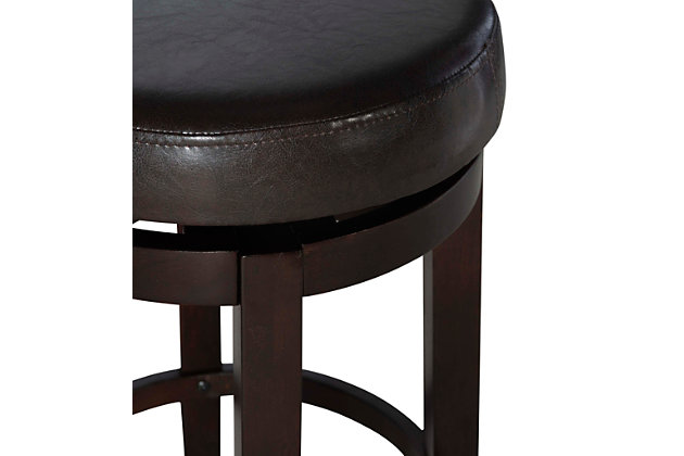 Raise the bar on style with this simply striking upholstered bar stool in dark brown with brown upholstery. Thickly padded seat covered in easy-clean vinyl caters to your comfort level.Made of wood | Dark brown finish | Faux leather upholstery with foam padding | Nailhead trim | Protective glides under legs | Assembly required