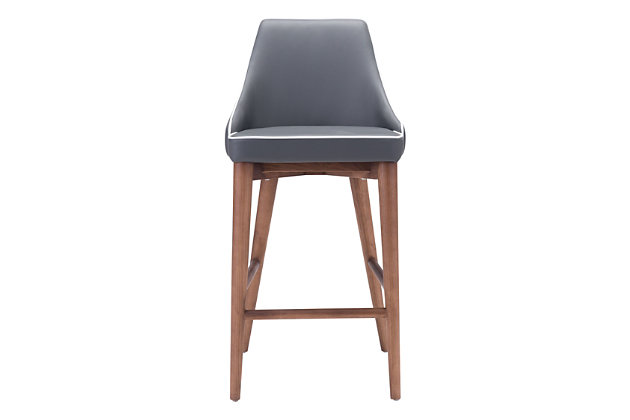 Create an effortlessly elegant look with this upholstered designer bar stool with slim wing back styling. Back and seat are wrapped in a feel-good faux leather punctuated with accent trim detail. Sturdy all-wood base in a warm walnut-tone finish makes a striking complement.Wood base in walnut-tone finish | Padded faux leather upholstery | Assembly required