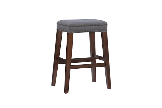 Timeless and versatile, the Monroe stool is a stylish addition to a kitchen or bar. Crafted of sturdy wood in a walnut finish, this backless stool caters to your comfort with a cushioned seat covered in a solid gray plush upholstery and embellished with antique brass-tone nailhead trim. Four footrails provide added stability. Bar height.Made of wood | Bar stool | Backless design | Gray upholstered seat | Walnut finish | Antique brass-tone nailhead trim | Seat height 30.5" | Assembly required