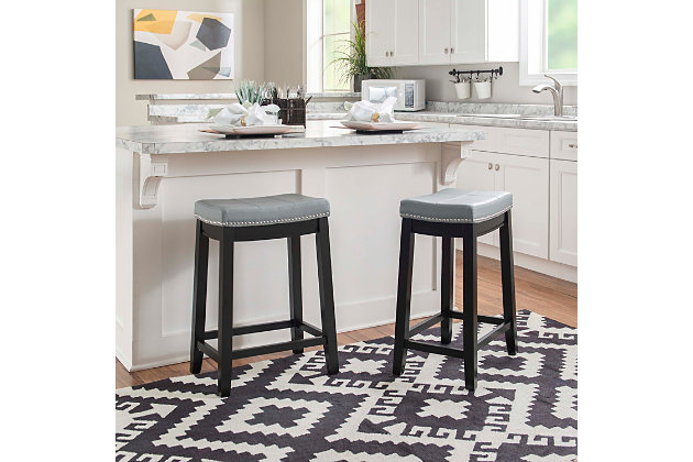 Add timeless style and cozy comfort to your counter or high top table with the Claridge backless barstool. Crafted from sturdy wood in a black finish, this simply chic stool is upholstered in a gray vinyl fabric and embellished with shiny silvertone nailhead trim for eye-catching detail. Counter height.Made of wood | Black finish | Shiny silvetone nailhead trim | Gray vinyl upholstered seat | Seat dimensions: 24" seat height, 16.93" x 11.81" x 2.76" | 275 lb. weight limit | Foam cushion | Assembly required