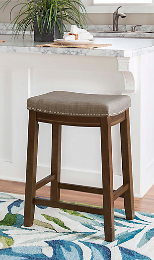The Claridge counter stool will add stylish seating to any counter or high top table. The sturdy wood frame has a rustic finish accented by a gray polyester upholstered seat. Brushed silvertone nailhead trim adds an eye-catching detail.Made of wood | Rustic finish | Brushed silvertone nailhead trim | Gray polyester upholstered seat | Seat dimensions: 24" seat height, 16.93" x 11.81" x 2.76" | 275 lb. weight limit | Foam cushion | Assembly required