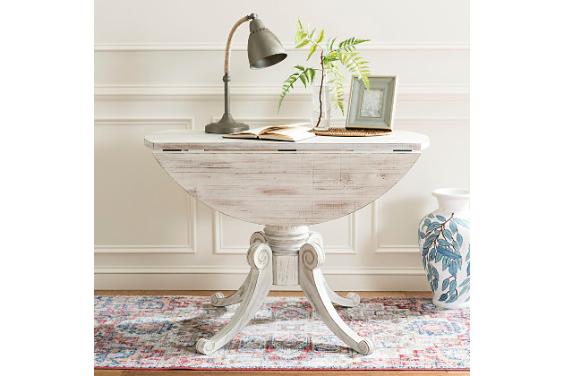 Create memories with friends and family around this beautiful drop leaf dining table. Its traditional design features a classic pedestal base and stunning carved details highlighted by a rich antique white finish. A timeless addition to any dining room.Dust regularly with a soft, dry cloth. Never use oiled or treated cloths on lacquered finishes. Some finishes can be wiped with a damp (not wet) cloth, followed at once by rubbing with a dry cloth to remove fingerprints and smudges. For persistent spots, gently clean with a soft cloth and a solution of water and mild soap, make sure to wipe dry. Use adhesive felt pads, coasters and placemats to protect your furniture. | 0