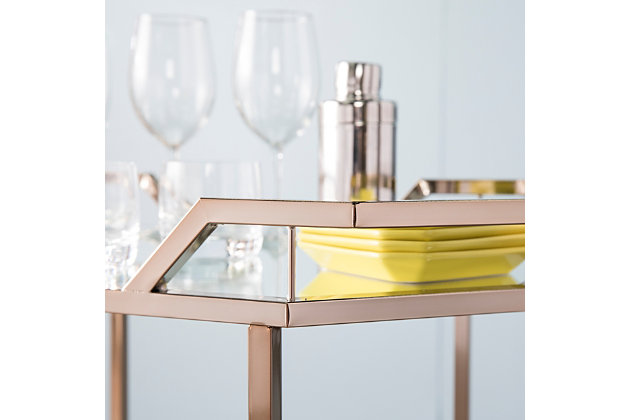 You’re the life of the party with this 1920s-style mirrored bar cart. Mirrored shelves add depth and dimension to your fabulous bar collection, while an elegant champagne finish elevates your art deco lifestyle to the next level. Locking casters give you the freedom to take the party from room to room. Reflect on the finer things with this metal drink cart with wheels.Plated iron frame in champagne finish | 3 tempered mirrored glass shelves | Locking casters for easy mobility/stability | Assembly required | Assembly time frame is 15 to 30 min.