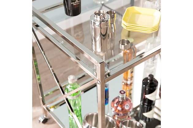 Conjure a scene a la Gatsby with this elegant bar cart. Sleek, linear architecture contrasts with the luxurious metallic chrome-tone finish, high-shine mirrored shelf and glossy glass tabletop. X-frame sides give a nod to the lavish lifestyles of the '20s, while two open shelves provide plenty of space for your martinis, stemware and garnishes. Designed to keep the party on a roll, this cart includes two safety casters that lock into place.Plated iron frame in metallic chrome-tone finish | 5-mm tempered glass top | 5-mm mirrored glass shelf | Locking casters for easy mobility/stability | Assembly required | Assembly time frame is 15 to 30 min.