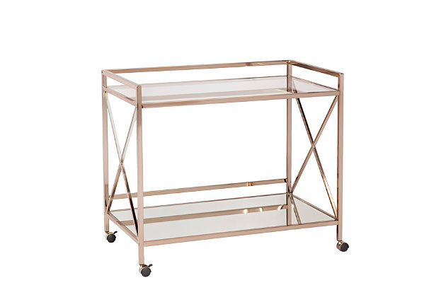 Conjure a scene a la Gatsby with this elegant bar cart. Sleek, linear architecture contrasts with the luxurious metallic goldtone finish, high-shine mirrored shelf and glossy glass tabletop. X-frame sides give a nod to the lavish lifestyles of the '20s, while two open shelves provide plenty of space for your martinis, stemware and garnishes. Designed to keep the party on a roll, this cart includes two safety casters that lock into place.Plated iron frame in metallic goldtone finish | 5-mm tempered glass top | 5-mm mirrored glass shelf | Locking casters for easy mobility/stability | Assembly required | Assembly time frame is 15 to 30 min.