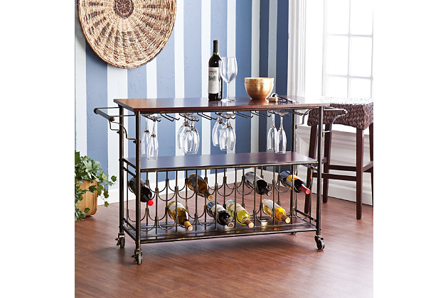 No need to worry if the party moves from the kitchen to the dining room; tasty treats and libations will never be far behind with this trendy bar cart. The black and brushed goldtone frame supports espresso-colored shelves to serve your needs. And with room to hang 18 glasses and 18 wine bottles, you can be sure the good times will flow.Black iron frame with engineered wood | Shelf and spacious countertop for serving and storage | Holds 18 bottles/18 glasses (9 glassware racks) | 2 towel racks | Smooth-gliding casters for easy mobility | Assembly required | Assembly time frame is 15 to 30 min.