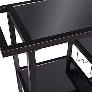 High style, brilliantly served. Keep the party rolling with this bar cart. Its combination of a sleek black frame and smoky gray glass is so contemporary. Stemware racks and bottle holders keep your breakables in place. Shelves accommodate mixers and assorted accoutrements.Iron frame in black finish | 5-mm smoked glass mirrored surfaces | 4 tiers | Wine rack and 4 glassware racks (holds approximately 8 glasses) | Locking casters for easy mobility/stability | Assembly required | Assembly time frame is 15 to 30 min.