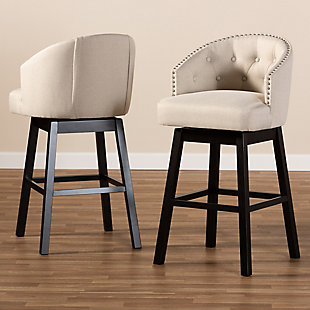 Bring happy hour to your home with the elegant Theron bar stool. Constructed from solid rubberwood, it showcases a stunning dark brown finish. The seat and back are upholstered in polyester fabric and padded with foam for endless comfort as you sip cocktails. A built-in footrest provides additional comfort, while button tufting and silver-finished nailheads add a touch of glamour. Equipped with swivel capability, it's well suited for both a kitchen or bar setting. The Theron bar stool is made in Malaysia and requires assembly.Set of 2 | Made of rubberwood in an espresso finish | Polyester fabric upholstery | Swivel capability | Button tufting and silver-finished nailheads | Assembly required