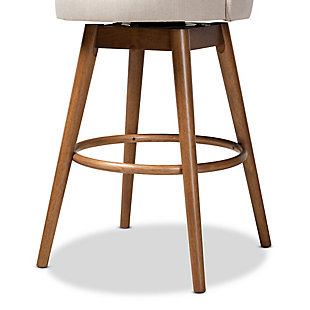 Enhance your home bar with the retro charm of the Carra bar stool. Constructed from solid rubberwood and wood veneer, the Carra showcases a warm walnut brown finish that complements the polyester fabric upholstery. The seat and back are padded with foam for endless hours of comfort as you sip cocktails. The swivel seat and built-in footrest provide additional comfort, while tapered, angled legs lend a chic mid-century look. The Carra bar stool is made in Malaysia and requires assembly.Set of 2 | Walnut brown finish | Upholstered in polyester fabric and padded with foam | Swivel capability | Made of rubberwood | Assembly required