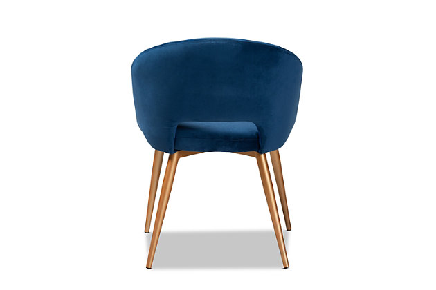 A retro design gets a luxurious update in the Vianne dining chair. Upholstered in a soft, sumptuous navy blue velvet fabric, the Vianne features a curved back and wide seat for the utmost dining comfort. The cut-out back design and splayed gold-tone legs give this chair a glamorous mid-century look.  Use this versatile piece as a dining chair or as an accent chair in the living room. The Vianne dining chair is made in China and requires assembly.Glam and Luxe dining chair | Constructed from metal | Upholstered in velvet polyester fabric and padded with foam | Goldtone finish