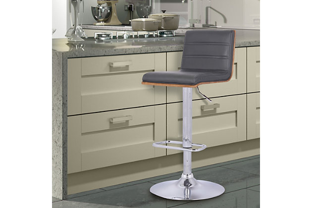 The contemporary-style Aubrey bar stool features adjustable height and 360-degree swivel functionality, making it a good fit for the kitchen counter, home bar area, or any gathering area. Its chrome finish and walnut wood veneer are complemented by a faux leather seat and back to blend easily with any color scheme and room decor. The sturdy metal pedestal includes a footrest for added leg support. The Aubrey easily adjusts from counter height to bar height.Made of metal, wood and faux leather | Base with chrome finish | Gray upholstered seat | Walnut veneer finish on back | 360-degree swivel allows full mobility | Footrest offers leg support | Adjusts from counter height to bar height  | Assembly required