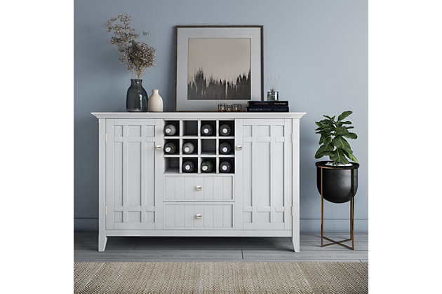 Need help in the dining room? This rustic sideboard buffet and wine rack is up to the job in a casual way. You'll find the moulded tabletop, beaded drawer fronts and sides, cabinets, wine rack and shelves handy for organizing dining essentials and keeping them within reach. It's hand-finished in white, with protective lacquer to accentuate and highlight the grain and uniqueness of each piece. This multi-functional storage cabinet can be used in the living room, family room or dining room.DIMENSIONS: 17" D x 54" W x 36" H | Handcrafted with care using the finest quality solid wood | Hand-finished in White and a protective NC lacquer | Multi-Functional storage cabinet can be used in living room, family room and dining room | Features two (2) central drawers with metal glides, two (2) side doors that open to large storage spaces with two (2) shelves each and a twelve (12) bottle wine storage rack. | Transitional Style includes molded table top, beaded drawer fronts and sides, solid panel doors and Bronze rounded square knobs | Assembly Required | We believe in creating excellent, high quality products made from the finest materials at an affordable price. Every one of our products come with a 1-year warranty and easy returns if you are not satisfied.