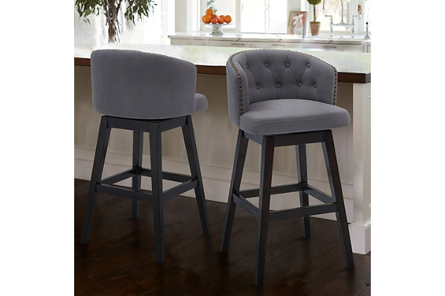 The Armen Living Celine wood barstool is an excellent choice for the transitional or contemporary household. Constructed from a combination of eucalyptus and birch wood frame that is certain to maintain its durability for many years to come. The Celine’s legs feature an Espresso wood finish and the plump, foam padded seat and back of the barstool are upholstered in grey fabric. The back of the Celine is rounded and features tufted accents that add a unique aesthetic accent to the piece. The barstool’s 360 degree swivel function allows for a wide range of movement while seated and the included footrest provides added comfort and support. The Celine’s legs are tipped with floor protectors, assuring that the barstool will not damage floors when moved. The Celine is sold in two industry standard sizes; 26 inch counter and 30 inch bar height. This wood barstool is available in gray or tan fabric.Celine contemporary bar or counter stool in espresso wood finish and grey or tan fabric | 360 degree swivel function allows for enhanced mobility while seated | Tufted back design is aesthetically pleasing and enjoyable | Product dimensions: 21"w x 21.5"d x 39"h sh: 30"