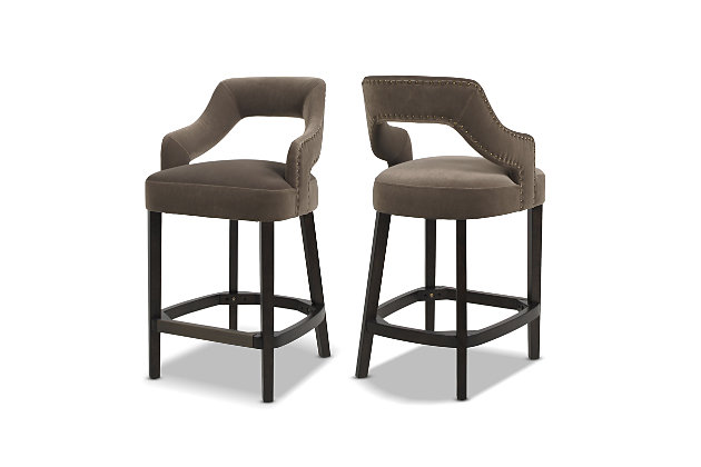 Elegantly modern, the Moderne Upholstered Bar Stool Collection by Jennifer Taylor Home features plush, comfortable seating that doesn’t skimp on style. Fully upholstered with luxurious velvet atop a medium-firm foam seat, these 26" high bar stools work great with kitchen counters, high tables, or anywhere you need seating with a little extra height. Attractive nailhead accents line the arms and back of this stool, and a brass kickplate helps prevent scuffs and scratches to the dark espresso legs. Every purchase includes 2 bar stools for the perfect pairing for your home.Handmade by master furniture craftsmen for the highest level of quality | Sturdy frame of kiln-dried solid birchwood and layered plywood provides excellent support and stability | Brass-plated footrest provides comfortable seating and resists scuffs and scratches | Hand-applied iron nailhead accents are finished in antique brass to provide classic chic | 2 matching stools included for perfect bar stool pairing