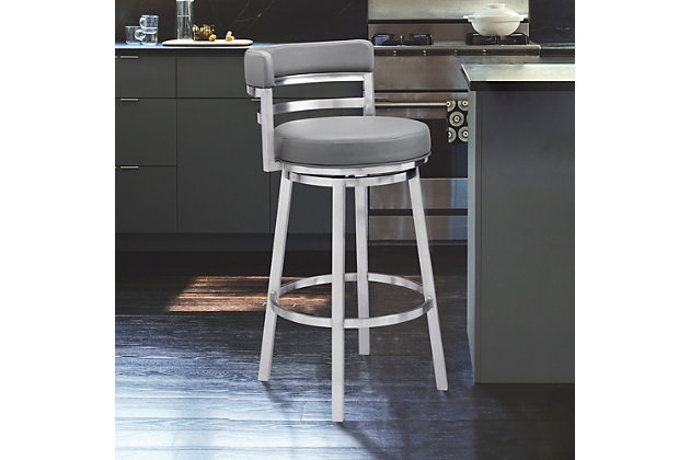 The Armen Living Madrid  armless barstool features a unique aesthetic that is certain to work well in any modern household. The Madrid’s durable brushed stainless steel frame is accompanied beautifully by its grey faux leather seat and back. The upholstered low back is rounded, providing the user with exceptional support while the 360 degree swivel seat allows for enhanced mobility. The Madrid’s contemporary straight leg design endows the barstool with a chic quality that is further accented by the inclusion of a round footrest. The Madrid’s legs are tipped with floor protectors, assuring that the barstool will not slip on or scratch hardwood or tile floors. The beautiful Madrid is available in two industry standard sizes; 26 inch counter and 30 inch bar height.Sturdy construction for years of enjoyment | Available in two industry standard sizes; 26 inch counter and 30 inch bar height | Round foot rest adds a nice stylistic accent while balancing the barstool | Product dimensions: 20"w x 21"d x 34.5"h sh: 26" | Round footrest with brushed chrome-tone finish | Floor protectors | Available in 26" counter and 30" bar height | Assembly required | Comes with a standard 1-year limited warranty