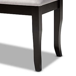 Add casual elegance to your dining room set up with the Cornelie dining bench. This bench is constructed from sturdy wood, with its sleek dark brown finish complementing the soft, gray fabric upholstery. An optimal balance of comfort and style, this bench features a plush foam-padded seat, as well as classic cabriole legs that enable ample leg room. The Cornelie dining bench is well suited for both casual and formal dining.Made of oak wood and rubberwood | Dark brown finish | Upholstered in polyester fabric and padded with foam | Cabriole legs | Assembly required