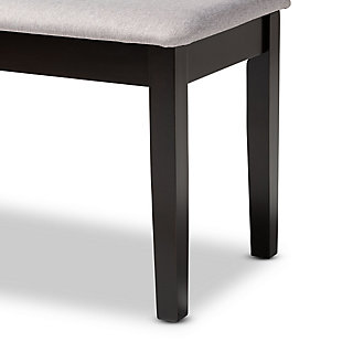 Add casual elegance to your dining room set up with the Teresa dining bench. This bench is constructed from sturdy wood, with its sleek dark brown finish on the wood complementing the soft, gray fabric upholstery. An optimal balance of comfort and style, this bench features a plush foam-padded seat, as well as long, straight legs that enable ample leg room. The Teresa dining bench is well suited for both casual and formal dining.Made of oak wood and rubberwood | Dark brown finish | Upholstered in polyester fabric and padded with foam | Straight legs | Assembly required