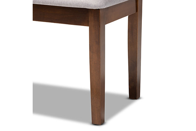 Add casual elegance to your dining room set up with the Teresa dining bench. This bench is constructed from sturdy wood, with its warm walnut brown finish complementing the soft, gray fabric upholstery. An optimal balance of comfort and style, this bench features a plush foam-padded seat, as well as long, straight legs that enable ample leg room. The Teresa dining bench is well suited for both casual and formal dining.Made of oak wood and rubberwood | Walnut brown finish | Upholstered in polyester fabric and padded with foam | Straight legs | Assembly required