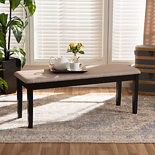 Add casual elegance to your dining room set up with the Teresa dining bench, This bench is constructed from sturdy wood, with its sleek dark brown finish complementing the soft, sand fabric upholstery. An optimal balance of comfort and style, this bench features a plush foam-padded seat, as well as long, straight legs that enable ample leg room. The Teresa dining bench is well suited for both casual and formal dining.Made of oak wood and rubberwood | Dark brown finish | Upholstered in polyester fabric and padded with foam | Straight legs | Assembly required