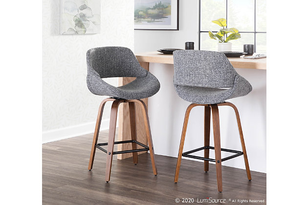The wide and welcoming seat of the LumiSource Fabrico Counter Stool beckons one to sit and relax. A curved back and contoured upholstered seat is accented by flared walnut wood swivel legs that add to the stylish yet comfortable design. Available in a variety of upholstery colors, choose the one that suits your space best.Mid-century modern styling | Fixed counter height | Square built-in footrest with black finish | Padded seat and backrest for added comfort | Includes two counter stools