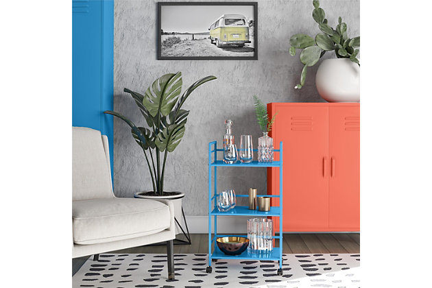 From the living room to the bathroom to the kitchen and beyond, the Novogratz Cache Metal Rolling Cart is a great addition to your home. Featuring a minimalistic style, the Cart has 3 large shelves. Each shelf has 3 wrap-around bars and can hold up to 20 lbs. Place glasses, your favorite drinks, and decanter on the shelves for a stylish bar and serving cart or use as a craft cart or office cart to organize your printer, paper, and craft supplies. Easily roll the Cart from room to room on the 4 casters, 2 of which lock into place. The storage possibilities are endless with this versatile cart. Thanks to the blue powder-coated metal finish, this Cart will add a fun and funky pop of color to any space. The Cart ships flat to your door and requires assembly upon opening. Two adults are recommended to assemble. Once assembled, the Cart measures to be 30.11”H x 16.81”W x 11.4”D.Use the novogratz cache rolling cart anywhere you need to add storage space | The blue finish on the powder-coated metal adds a fun pop of color and can easily be cleaned by wiping with a damp cloth | Three large shelves with wraparound bars on 3 sides allows you to organize glasses, toiletry items, craft supplies, and or make the cart into a fun coffee bar | The rolling casters make it easy to move the cart where ever you need and 2 casters lock to keep the cart in place | The cart ships flat to your door and 2 adults are recommended to assemble. Each shelf can hold up to 20 lbs. Assembled dimensions: 30.11”h x 16.81”w x 11.4”d | 1 year limited warranty is included
