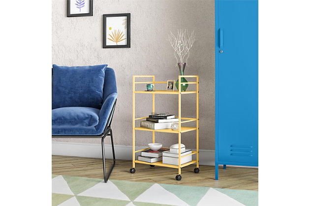 From the living room to the bathroom to the kitchen and beyond, the Novogratz Cache Metal Rolling Cart is a great addition to your home. Featuring a minimalistic style, the Cart has 3 large shelves. Each shelf has 3 wrap-around bars and can hold up to 20 lbs. Place glasses, your favorite drinks, and decanter on the shelves for a stylish bar and serving cart or use as a craft cart or office cart to organize your printer, paper, and craft supplies. Easily roll the Cart from room to room on the 4 casters, 2 of which lock into place. The storage possibilities are endless with this versatile cart. Thanks to the yellow powder-coated metal finish, this Cart will add a fun and funky pop of color to any space. The Cart ships flat to your door and requires assembly upon opening. Two adults are recommended to assemble. Once assembled, the Cart measures to be 30.11”H x 16.81”W x 11.4”D.Use the novogratz cache rolling cart anywhere you need to add storage space | The yellow finish on the powder-coated metal adds a fun pop of color and can easily be cleaned by wiping with a damp cloth | Three large shelves with wraparound bars on 3 sides allows you to organize glasses, toiletry items, craft supplies, and or make the cart into a fun coffee bar | The rolling casters make it easy to move the cart where ever you need and 2 casters lock to keep the cart in place | The cart ships flat to your door and 2 adults are recommended to assemble. Each shelf can hold up to 20 lbs. Assembled dimensions: 30.11”h x 16.81”w x 11.4”d | 1 year limited warranty is included
