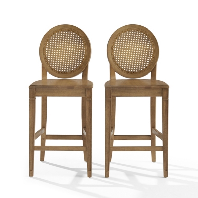 Two wooden counter height stools with caned round backs side by side