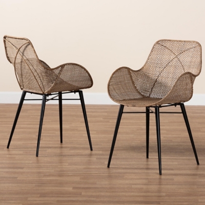 Pair of woven dining chairs on wood floor