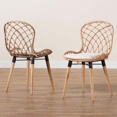 Two rattan dining chairs on wooden floor