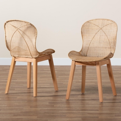 Two natural rattan dining chairs placed on a hardwood floor.